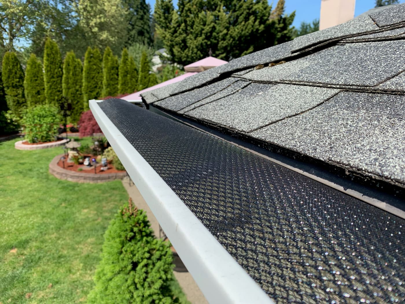 Black gutter mesh guard installed along a home's gutter line in Katy, TX